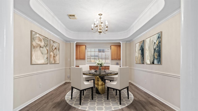 dining space featuring an inviting chandelier, dark wood-style flooring, crown molding, and baseboards