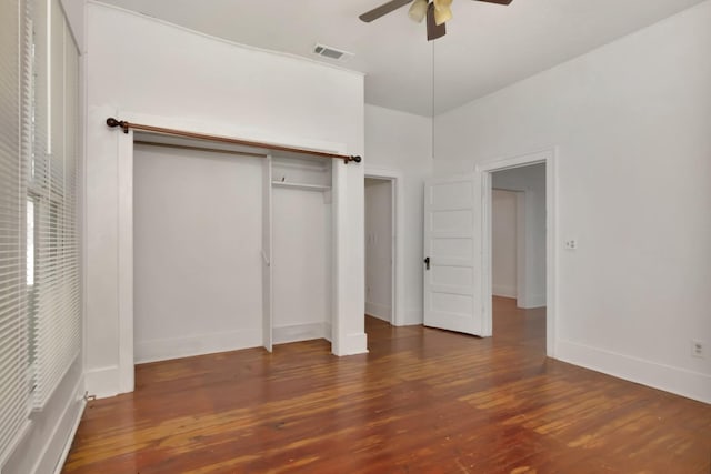 428 E Magnolia St, Angleton, TX 77515 - unfurnished bedroom featuring visible vents, baseboards, a closet, and wood finished floors