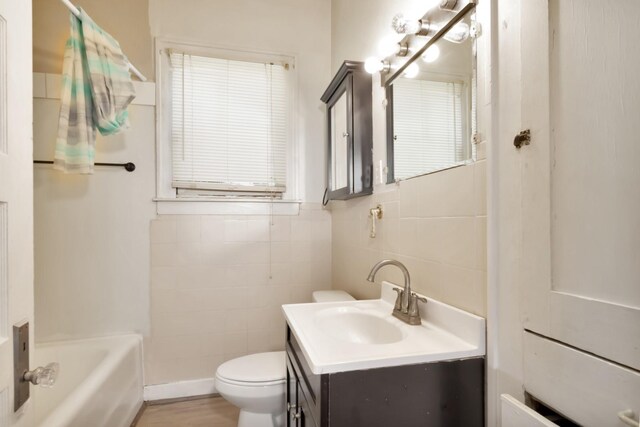 428 E Magnolia St, Angleton, TX 77515 - full bath featuring vanity, tile walls, toilet, and tub / shower combination