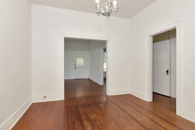 428 E Magnolia St, Angleton, TX 77515 - unfurnished dining area featuring a notable chandelier, baseboards, and hardwood / wood-style floors