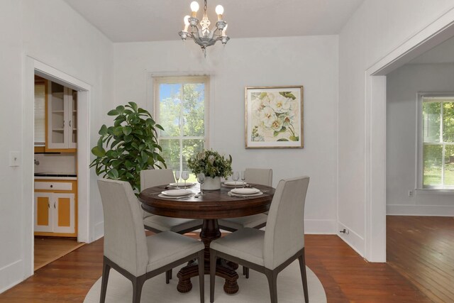 428 E Magnolia St, Angleton, TX 77515 - dining space with wood finished floors, an inviting chandelier, and baseboards