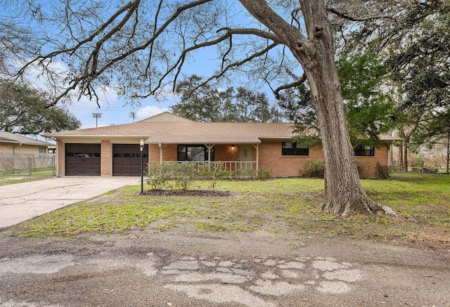 ranch-style house with driveway, brick siding, a garage, fence, and covered porch