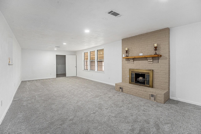 unfurnished living room with a fireplace, carpet flooring, visible vents, and baseboards