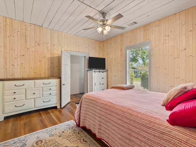 602 W 1st St, Freeport, TX 77541 - bedroom featuring wooden walls, wood finished floors, wooden ceiling, and a ceiling fan
