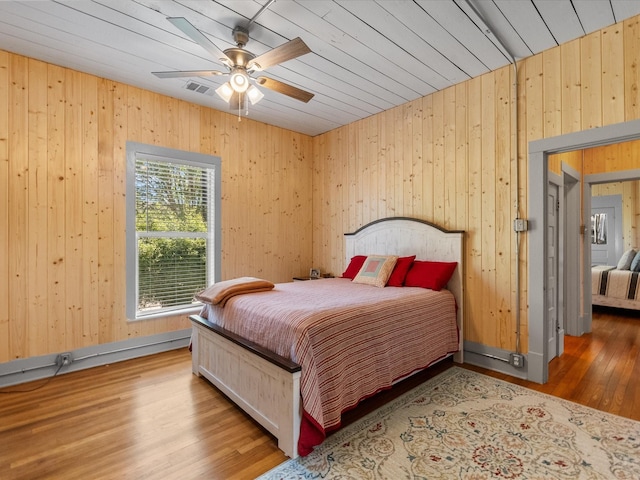 602 W 1st St, Freeport, TX 77541 - bedroom featuring wood walls, wood finished floors, and a ceiling fan