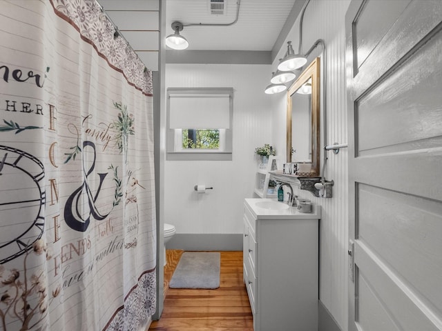 602 W 1st St, Freeport, TX 77541 - full bath with vanity, wood finished floors, and a shower with shower curtain