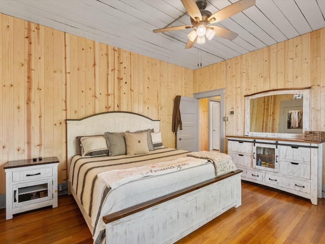 602 W 1st St, Freeport, TX 77541 - bedroom with wood walls, wooden ceiling, wood-type flooring, and a ceiling fan