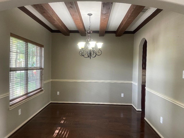 unfurnished room with a healthy amount of sunlight, arched walkways, beam ceiling, and wood finished floors