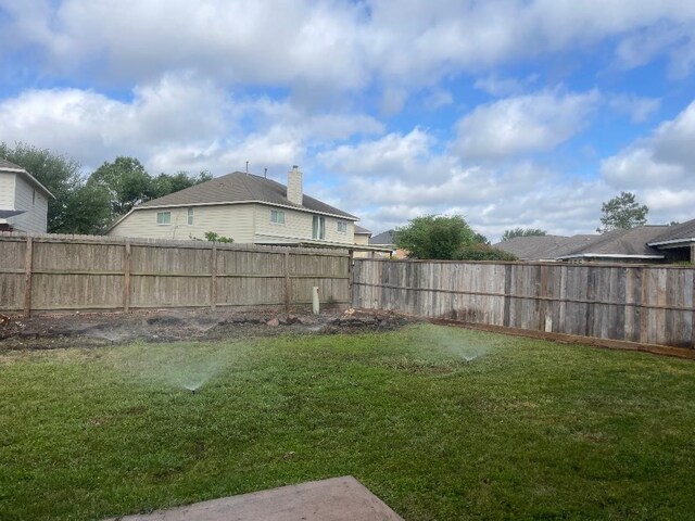 view of yard with a fenced backyard