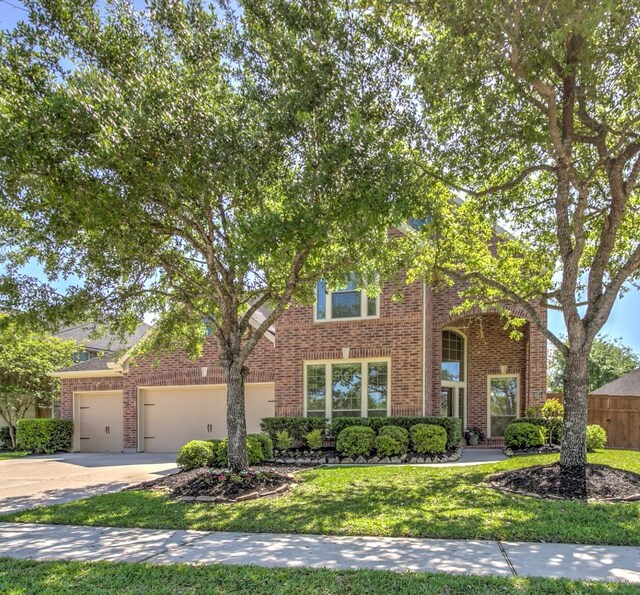 6103 Silver Thistle Ln, Fulshear, TX 77441 - view of front of house with brick siding, driveway, and a garage