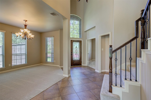 6103 Silver Thistle Ln, Fulshear, TX 77441 - carpeted foyer entrance with a chandelier, tile patterned flooring, stairs, and a towering ceiling
