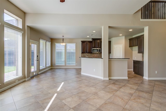 6103 Silver Thistle Ln, Fulshear, TX 77441 - unfurnished living room featuring light tile patterned flooring and recessed lighting