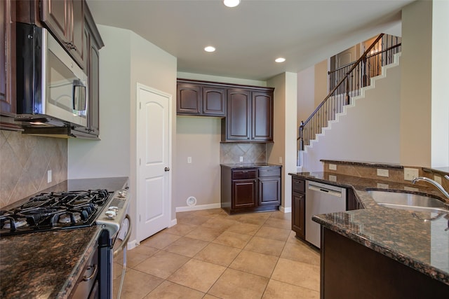 6103 Silver Thistle Ln, Fulshear, TX 77441 - kitchen with stainless steel appliances, tasteful backsplash, dark stone counters, dark brown cabinets, and recessed lighting