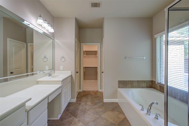 6103 Silver Thistle Ln, Fulshear, TX 77441 - full bath featuring vanity, a garden tub, and a walk in closet