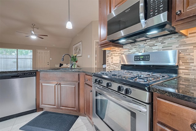 131 Breezy Shore Ct, Dickinson, TX 77539 - kitchen with a sink, appliances with stainless steel finishes, decorative backsplash, and light tile patterned floors
