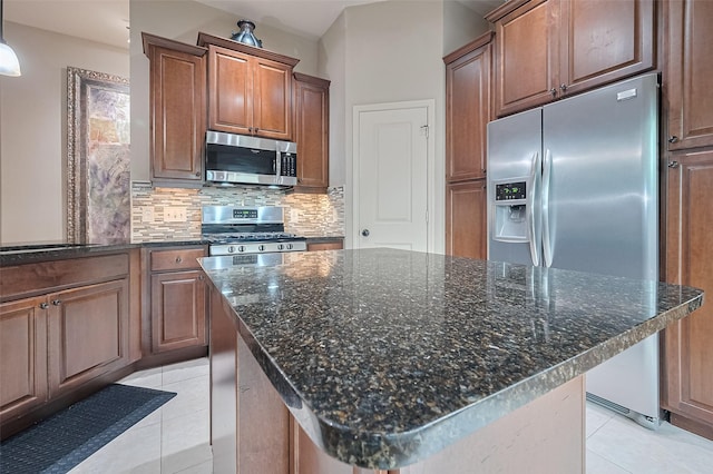 131 Breezy Shore Ct, Dickinson, TX 77539 - kitchen featuring decorative backsplash, appliances with stainless steel finishes, a kitchen island, and light tile patterned flooring
