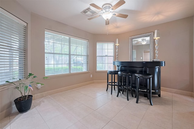 131 Breezy Shore Ct, Dickinson, TX 77539 - sitting room with baseboards, a ceiling fan, light tile patterned floors, and a dry bar