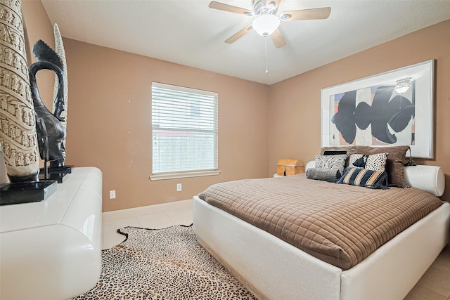 131 Breezy Shore Ct, Dickinson, TX 77539 - bedroom with tile patterned floors, ceiling fan, and baseboards