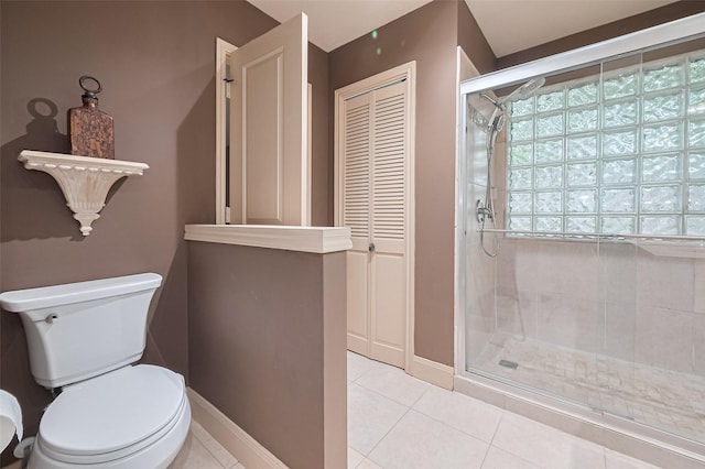 131 Breezy Shore Ct, Dickinson, TX 77539 - bathroom with tile patterned flooring, a closet, toilet, baseboards, and a shower stall