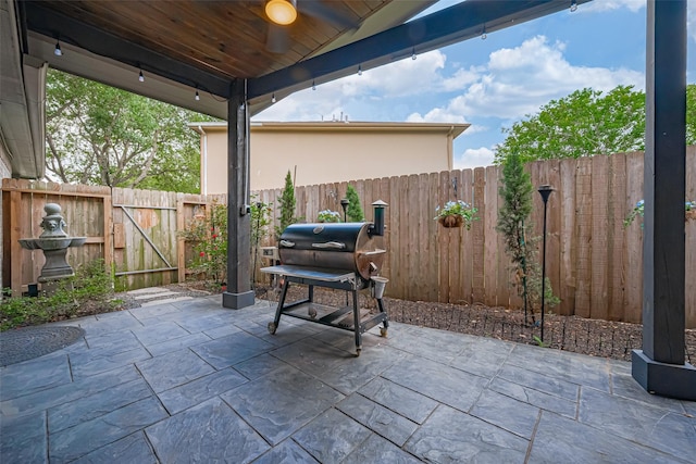 131 Breezy Shore Ct, Dickinson, TX 77539 - view of patio / terrace with a fenced backyard, a gate, and a grill