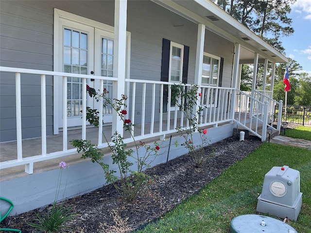 view of side of property featuring covered porch