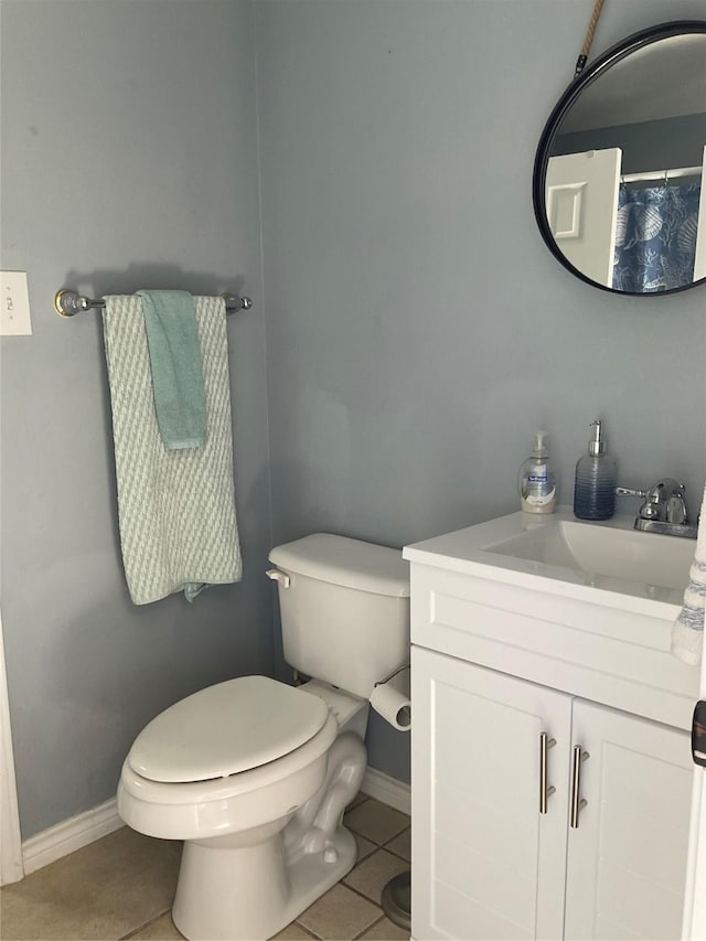full bathroom featuring toilet, tile patterned floors, vanity, and baseboards