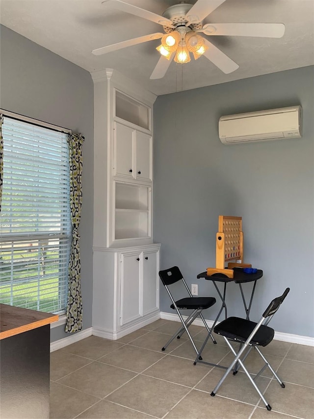 dining room with a wall mounted air conditioner, plenty of natural light, light tile patterned floors, and ceiling fan