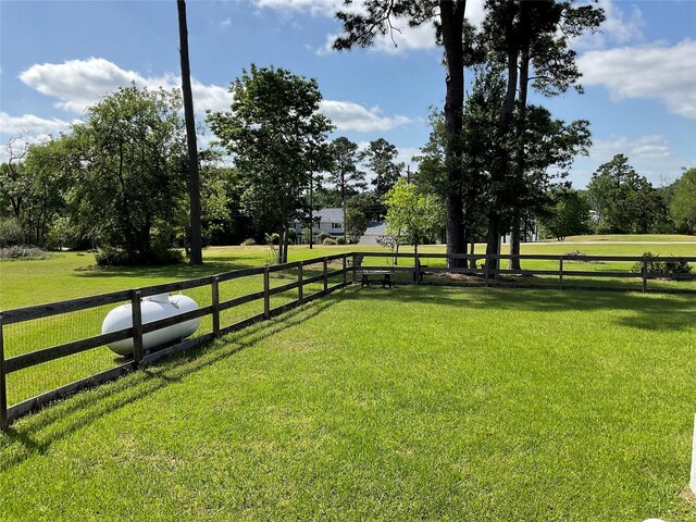 view of yard featuring a rural view and fence