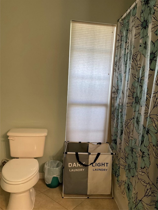 full bathroom with tile patterned floors, curtained shower, and toilet
