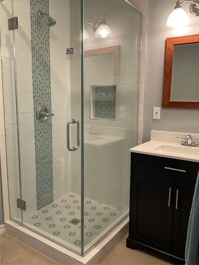 full bathroom with tile patterned flooring, vanity, and a stall shower