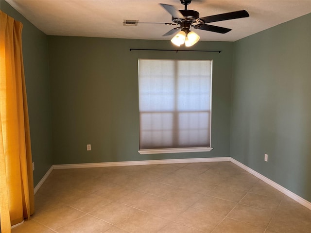 spare room featuring visible vents, ceiling fan, baseboards, and light tile patterned flooring