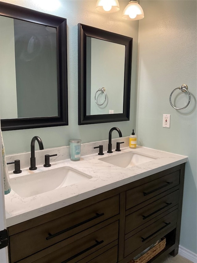 full bathroom with a sink and double vanity