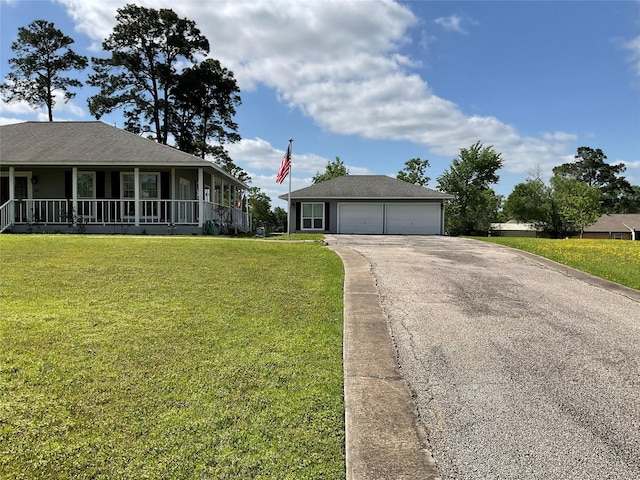 view of front of house with a porch, driveway, a front lawn, and a garage