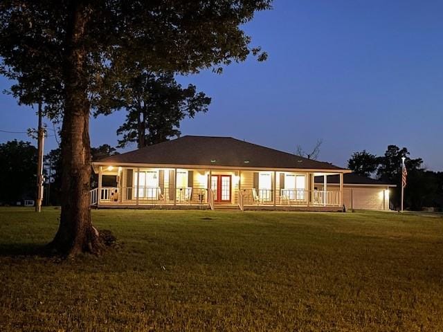 rear view of property featuring a wooden deck and a yard