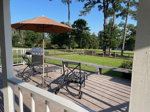 view of patio featuring a grill and fence