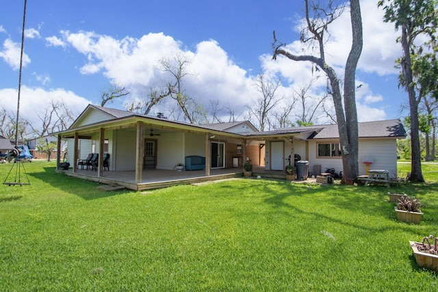 back of property featuring a yard and covered porch
