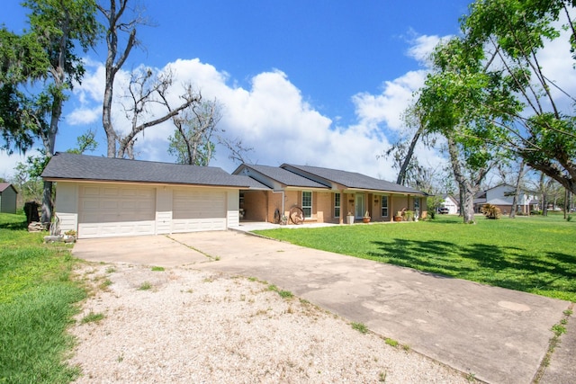 ranch-style house with an attached garage, driveway, and a front yard