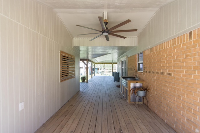 wooden terrace featuring ceiling fan