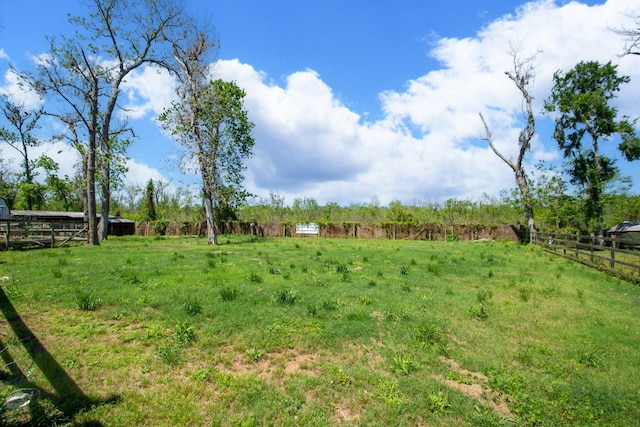 view of yard featuring a rural view and fence