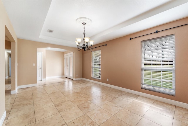 spare room with baseboards, visible vents, an inviting chandelier, and light tile patterned floors