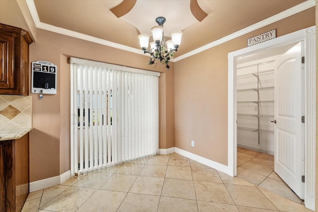 unfurnished dining area featuring ornamental molding, baseboards, a chandelier, and light tile patterned floors