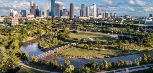 drone / aerial view featuring a city view and a water view