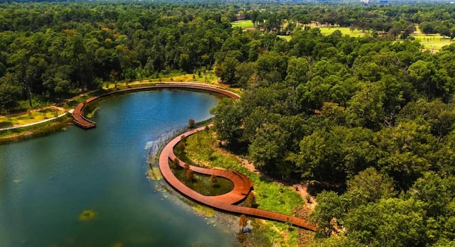 drone / aerial view featuring a water view and a wooded view