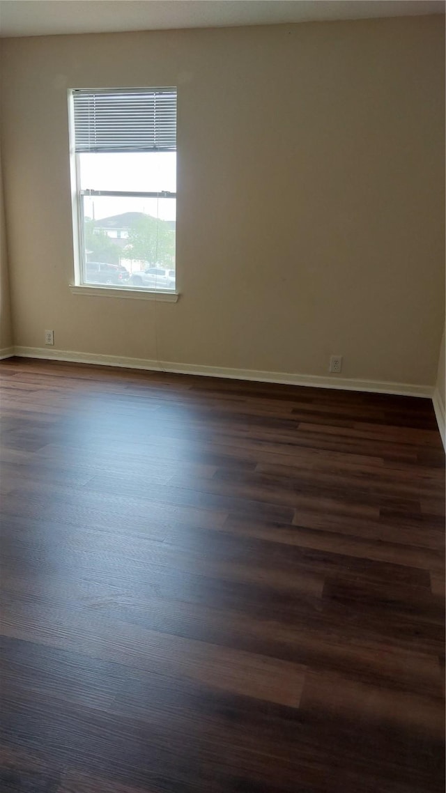 13411 Sarento Vlg, Sugar Land, TX 77498 - empty room with baseboards and dark wood-type flooring