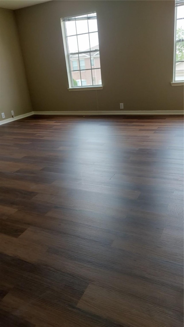 13411 Sarento Vlg, Sugar Land, TX 77498 - spare room with baseboards and dark wood-style flooring