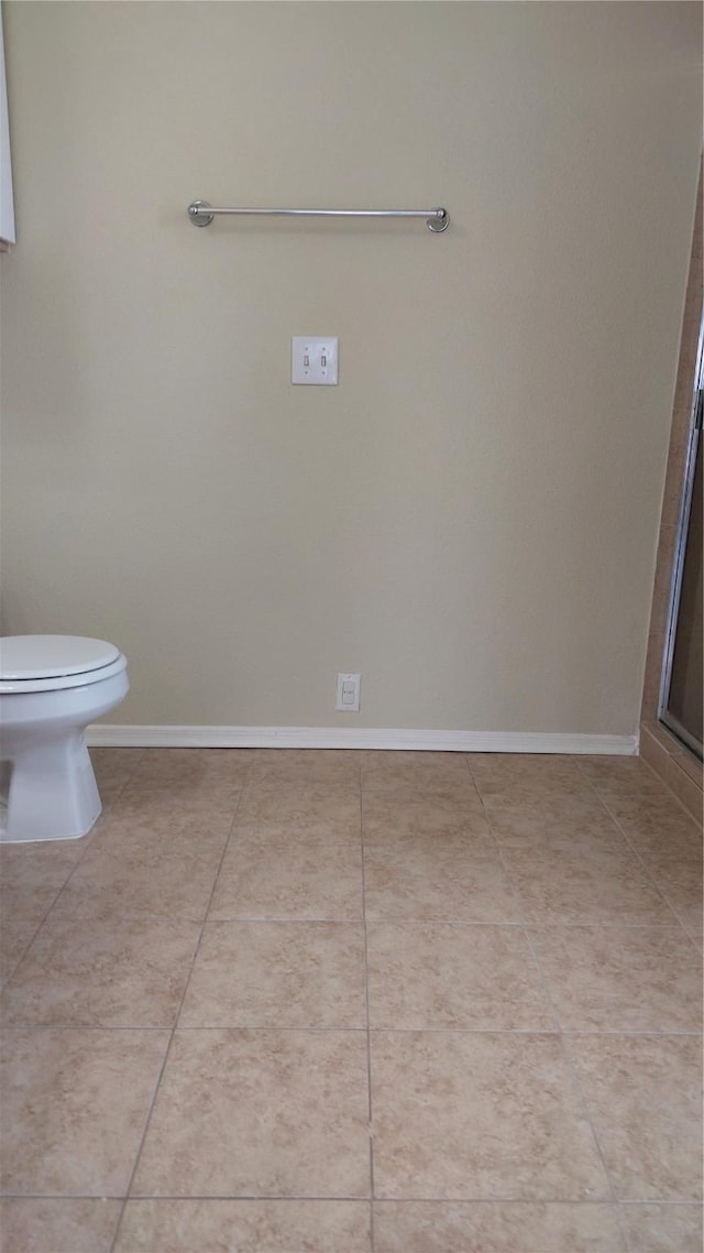 13411 Sarento Vlg, Sugar Land, TX 77498 - bathroom with tile patterned floors, toilet, a shower, and baseboards