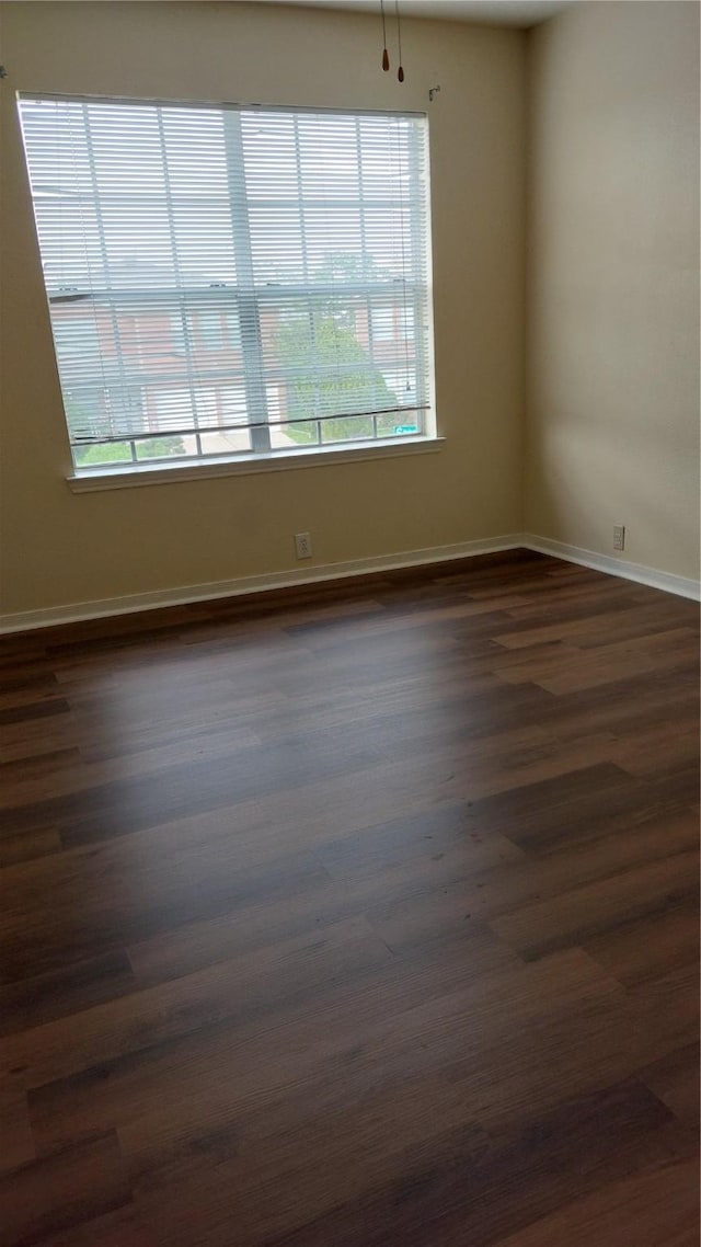 13411 Sarento Vlg, Sugar Land, TX 77498 - empty room featuring baseboards and dark wood-type flooring