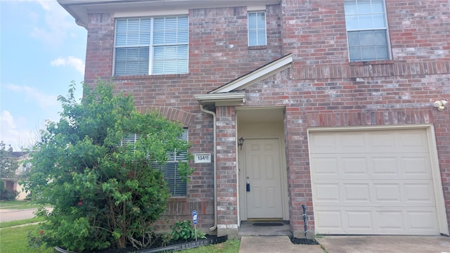 13411 Sarento Vlg, Sugar Land, TX 77498 - view of front facade with driveway, a garage, and brick siding