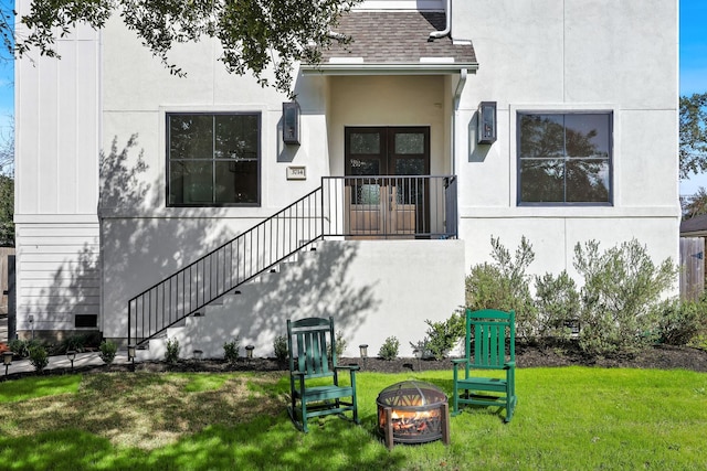 3714 Grennoch Ln, Houston, TX 77025 - property entrance with a yard, stucco siding, and a shingled roof
