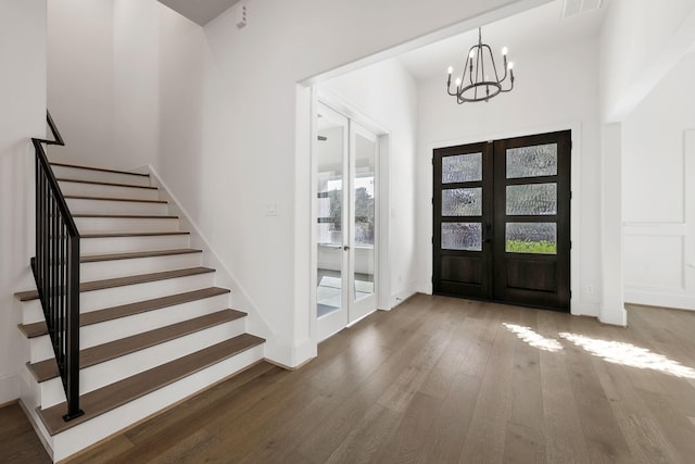 3714 Grennoch Ln, Houston, TX 77025 - foyer featuring french doors, wood finished floors, stairway, and a chandelier